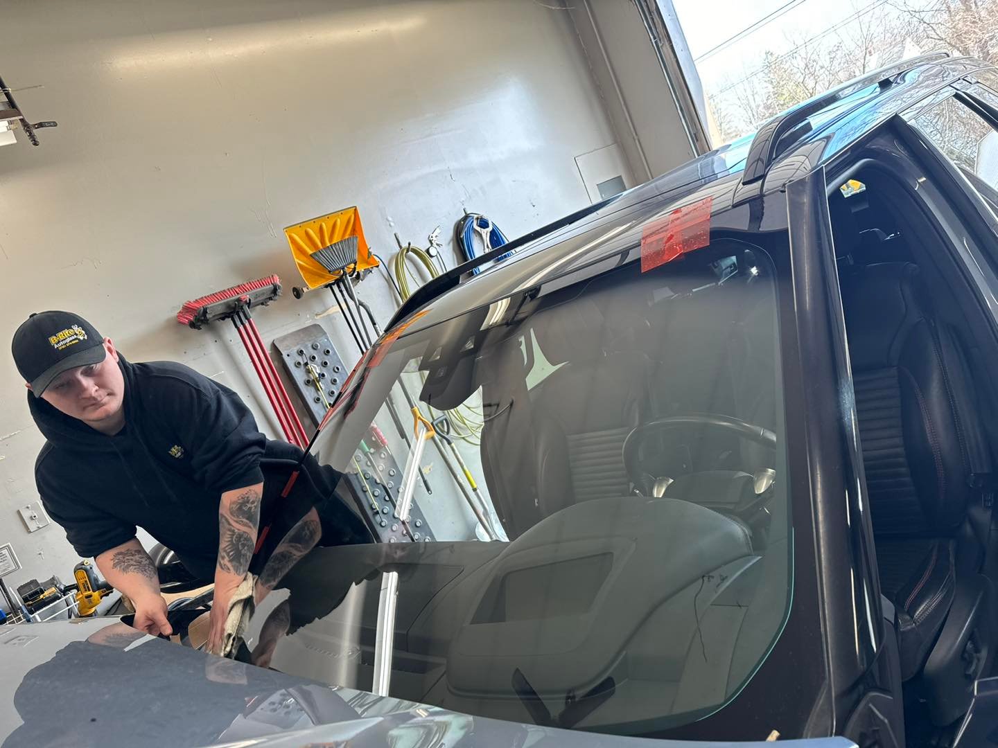 B-Rite technician finishing a windshield installation in the Madison IN shop